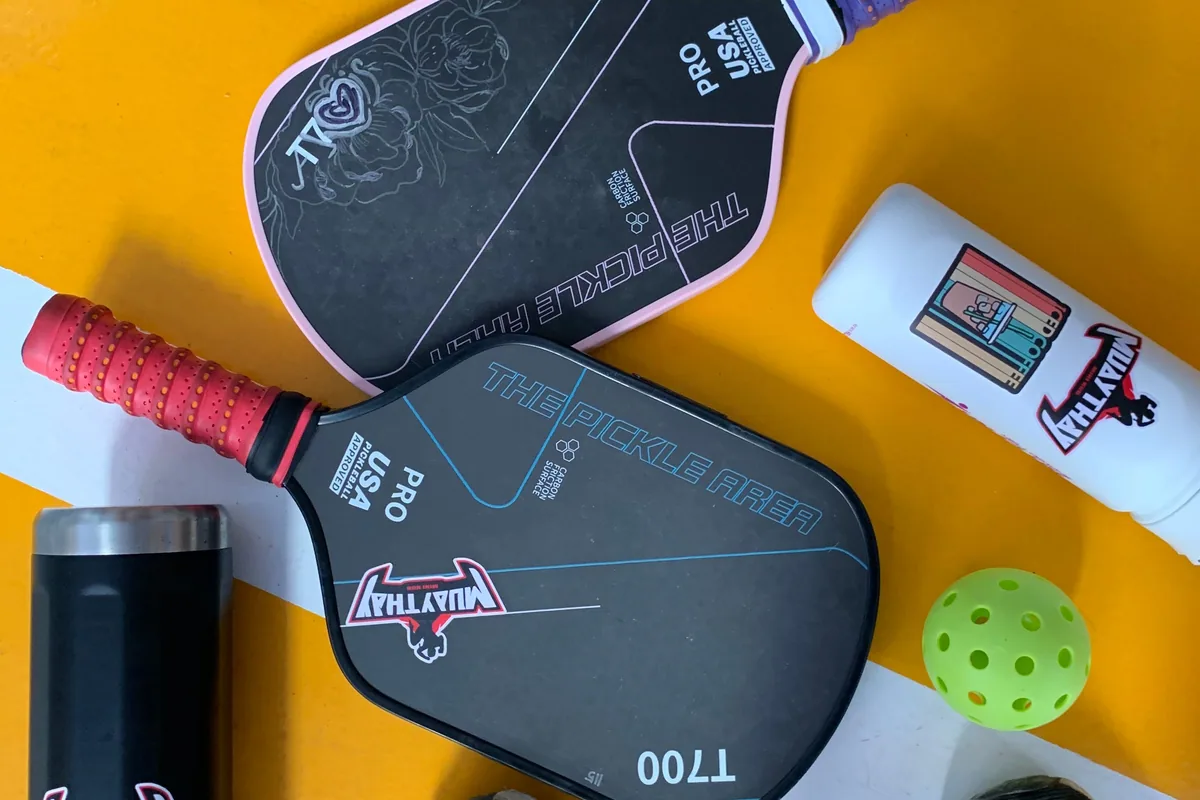 Pickleball paddles, ball and sports equipment on court