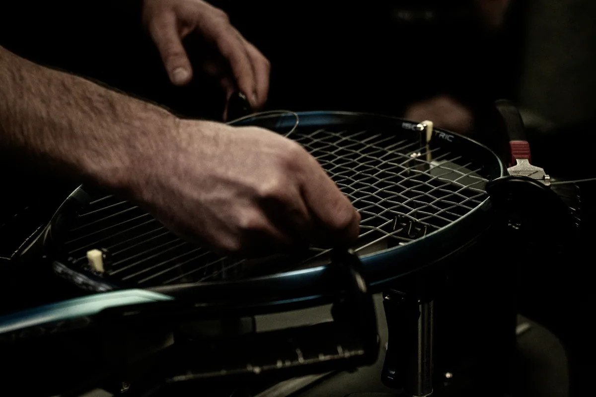 A tennis racket being strung
